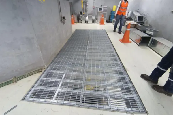 Rejillas metálicas instaladas en piso para ventilación en pasillo